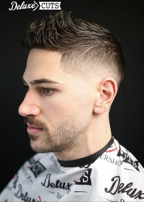 Textured quiff with a mid skin fade and shaped beard