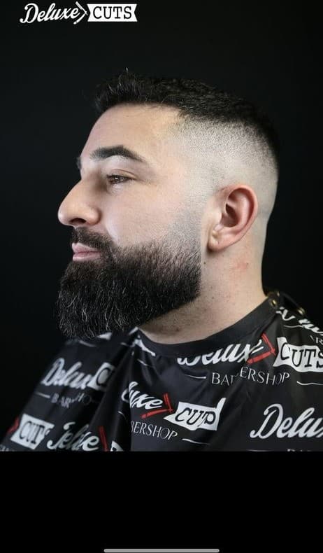 Bald fade with a full sculpted beard